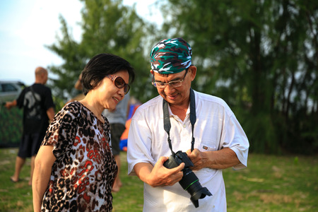 Ho Coc Beach, Vung Tau, Vietnam - July 13, 2014: Unknown, an Elderly couple are happy to share the pictures at the campsite on the shores of Lake Coc, Vung Tauのeditorial素材