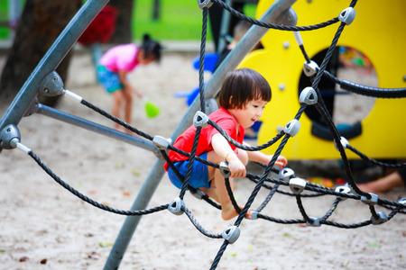 Ho Chi Minh City, Vietnam - June 21, 2015: unidentified, cute girl playing in a park alone tightrope in Ho Chi Minh City, Vietnamのeditorial素材