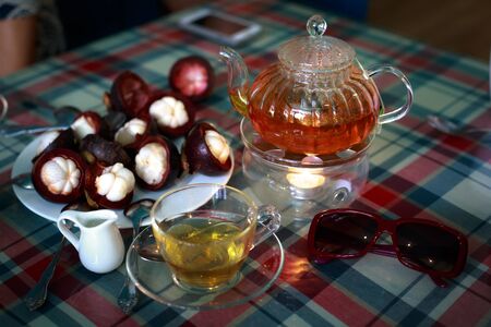 Tea Ceremony with heated herbal tea on candlesのeditorial素材