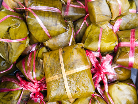 Vietnamese food, or pyramid shaped Banh Gio rice dumpling dough filled with pork, shallot, wrapped banana leaf print, street food is delicious, dish make from rice flourの写真素材