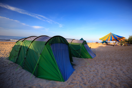 colorful tents in a sea beach camping site villageの写真素材