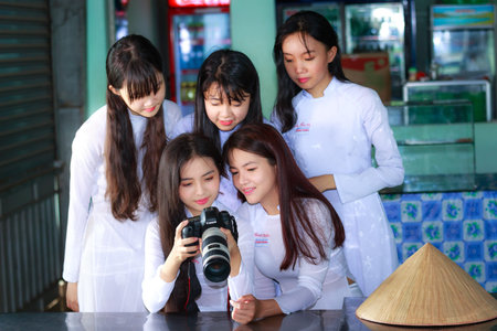 Hochiminh City, Vietnam - September 13, 2015: Unidentified Vietnamese Ao dai girls wear white...