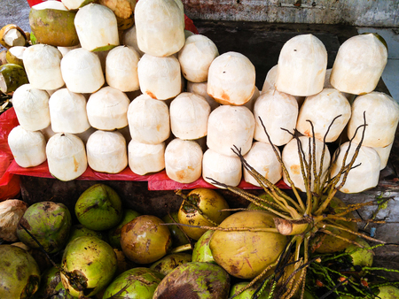 Coconut, tropical fruits are peeled sold print market, Vietnamの写真素材