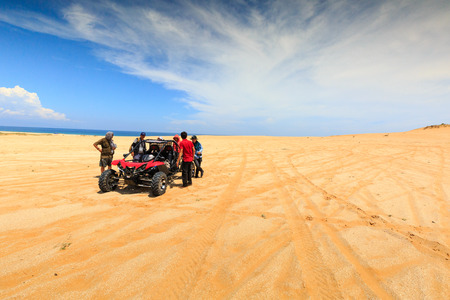 Ninh Thuan province, Vietnam-October 11, 2015: a group of tourists to explore the sand dunes are the prepared at the seaside the Mui Dinh, Binh Thuan Province by coach terrain vehiclesのeditorial素材