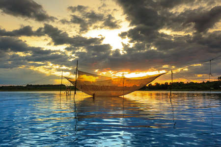 Calm scene of fishing net and purple sunset.の写真素材