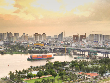 Hochiminh City, Vietnam - December 6, 2015: Saigon Bridge seen from above. Cargo shipping container...