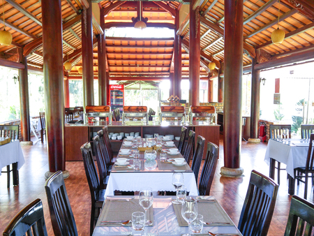 Dalat city, Vietnam - january 01, 2016: the tables were already prepared for the dining party to welcome  New Year at a luxurious restaurant with wooden furniture in the Dalat townのeditorial素材