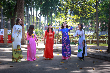 Hochiminh City, Vietnam - February 4, 2016: the young girls wearing traditional dress in a flower...
