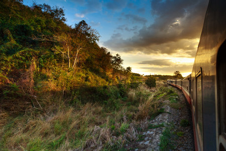 trains passing through wild prairie in sunset