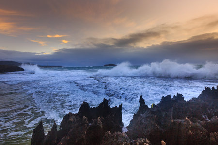 Amazing power of waves crashing against the rocks at dawn