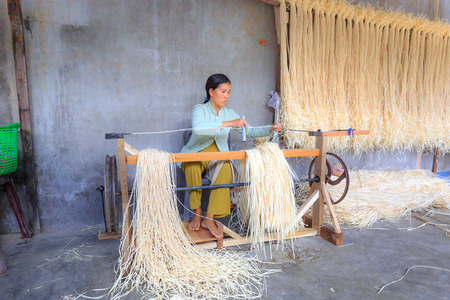 Ninh Thuan Province, Vietnam - February 27, 2016: at a craft village in Ninh Thuan province. Vietnam. A women weave the ropes from many papyrus fibersのeditorial素材