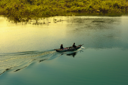 fishermen's small boat  on Lake Tri An and Tri An lake is a very large irrigation reservoir in Dong Nai province, Vietnamの写真素材