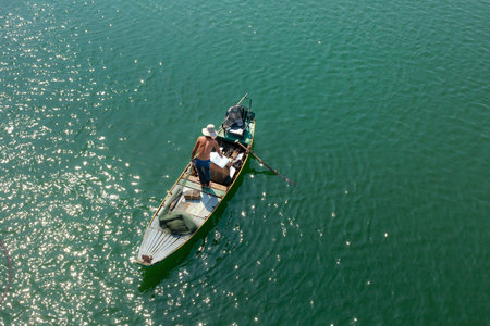 Tri An Lake, Dong Nai Province, Vietnam - March 6, 2016: A fisherman's boat on the lake in the early...