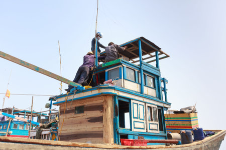 Lagi beach, Binh Thuan province, Vietnam - March 28, 2016 : at a repair workshop fishing boats. Skilled workers are repairing fishing boats for fishermenのeditorial素材