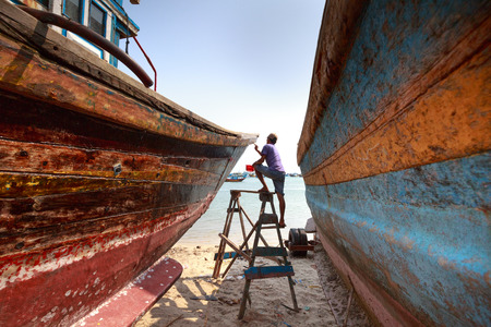 Lagi beach, Binh Thuan province, Vietnam - March 28, 2016 : at a repair workshop fishing boats. Skilled workers are repairing fishing boats for fishermenのeditorial素材