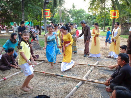 Ho Chi Minh City, Vietnam - March 5, 2016: a bamboo dancing scene in the culinary fair at the Van Thanh tourist area, Ho Chi Minh City. Bamboo dancing is a form of community activities of the ancient Vietnameseのeditorial素材