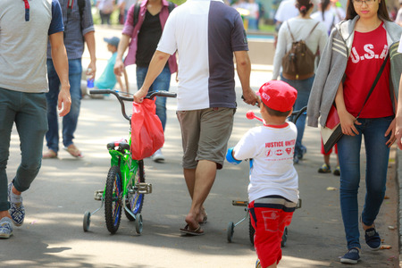 Ho Chi Minh City, Vietnam - March 13, 2016: A father and  his son after a cycling workout in a park in the HoChiMinh cityのeditorial素材