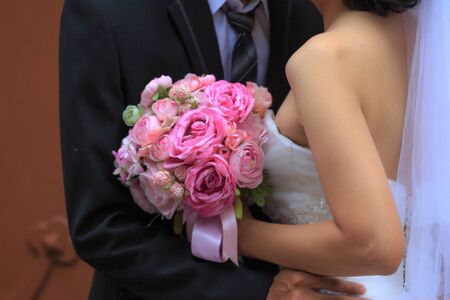 Hochiminh City, Vietnam - March 20, 2016 : wedding bouquet in hands of the bride and groomのeditorial素材