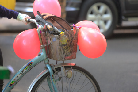 Hochiminh City, Vietnam - March 20, 2016 : happy in love with the bike and balloonsのeditorial素材