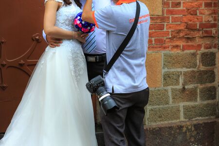 Hochiminh City, Vietnam - March 20, 2016 :Bride and groom standing together with flowers on wedding day photographer directing for photographsのeditorial素材