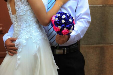 Hochiminh City, Vietnam - March 20, 2016 : wedding bouquet in hands of the bride and groomのeditorial素材