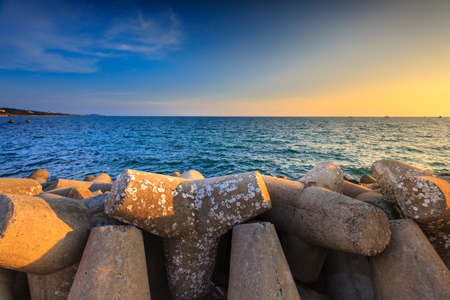 Amazing sunset at breakwater pier on Phu Quoc island . View sundown on the sea of Phu Quoc island, Vietnamの写真素材