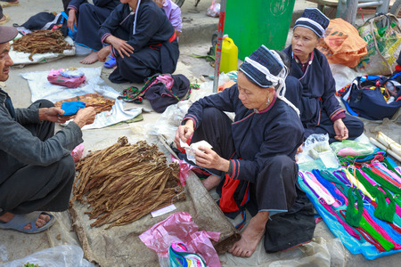 Hoang Su Phi, Ha Giang province, Vietnam - October 2, 2016: ethnic minority people set out the agricultural products homemade by themselves at the Sunday fair in Hoang Su Phi. they selling and exchanging homemade products such as : wine, textiles, colorfuのeditorial素材