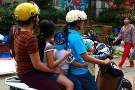 Hoang Su Phi, Ha Giang Province, Vietnam October 1, 2016: The happy five-member family on the motorbike on the way to the village market in the morning.のeditorial素材