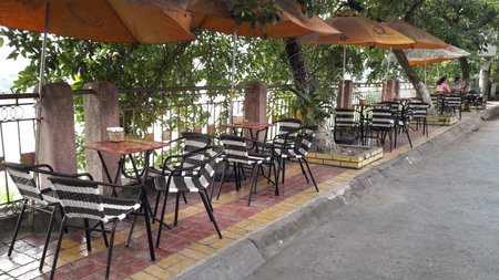 Lao Cai province, Vietnam - September 24, 2016: tables and chairs of a cafe by the river in Lao Cai province, Vietnamのeditorial素材