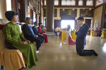 Truc Lam zen monastery in Vinh Phuc Province, Vietnam - October 19, 2016: at the Buddhist temple wedding ceremony, the bride and the groom bow to their parents to thank merits birth and upbringingのeditorial素材
