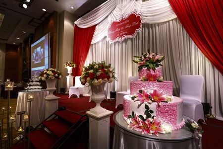 Ha Noi capital, VietNam - October 22, 2016 : Multi-tiered wedding cake decorated with pink lilies at a wedding in Ha Noi cityのeditorial素材