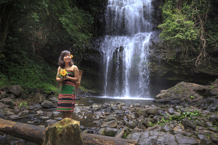 Dak Nong province, Viet Nam-January 14, 2017: A ethnic minority girl is having relaxing beside waterfallのeditorial素材