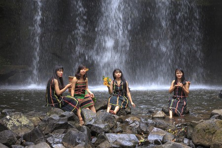 Dak Nong province, Viet Nam-January 14, 2017: the ethnic minority girls are bathing in streams beside waterfall in Dak Nong province, Vietnamのeditorial素材