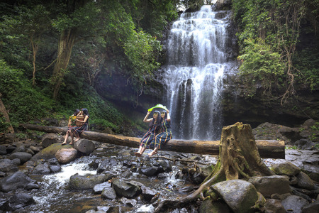 Dak Nong province, Viet Nam-January 14, 2017: the ethnic minority girls are having relaxing beside waterfallのeditorial素材