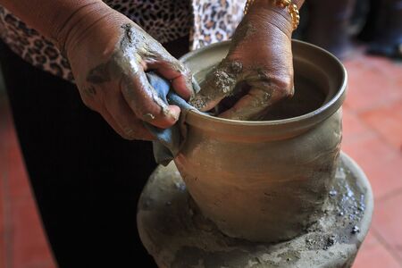 Bau Truc pottery village, Phan Rang city, Vietnam - December 24, 2016: Photo taken near the hands of a pottery artist creates clay vase traditional handicraft in Bau Truc pottery village in Phan Rang, Vietnam. Using traditional techniques.のeditorial素材