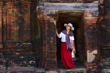 Cham tower, Phan Rang city, Viet Nam - December 25, 2016: a female tourist beside ancient wall of Cham towerのeditorial素材