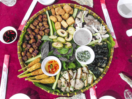 Vietnamese traditional variety food is presented on a bamboo plate for tourists to enjoyの写真素材