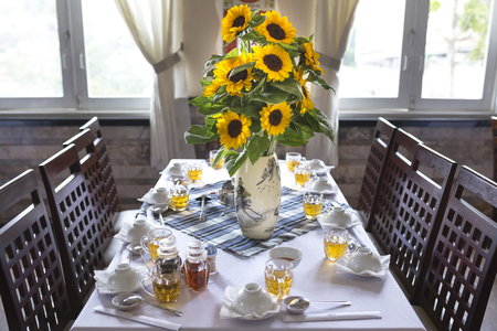 Da Lat town, Viet Nam - February 19th, 2017: beautiful sunflower vase is decorated on the dining table of a restaurant in the Dalat town, Vietnamのeditorial素材
