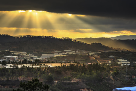 Da Lat town, Vietnam - February 18, 2017: Image of the sunrays into the sunset down a valley with full of greenhouses in Da Lat town, Viet Namのeditorial素材