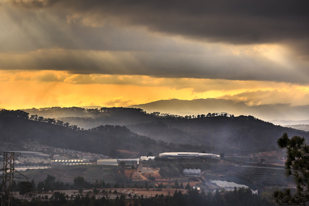 Da Lat town, Vietnam - February 18, 2017: Image of the sunrays into the sunset down a valley with full of greenhouses in Da Lat town, Viet Namのeditorial素材
