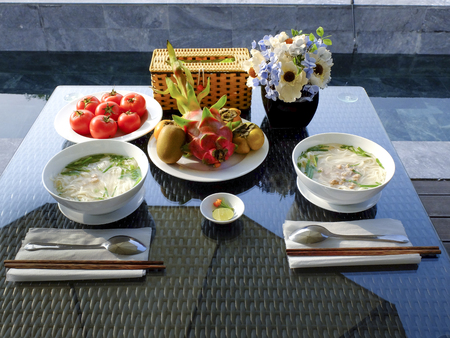healthy breakfast in the garden at summer with soup and fruitの写真素材