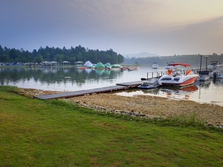 Flamingo Dai Lai Resort, Vinh Phuc, Vietnam - October 09, 2016 :  Boat moored at a wooden pier in a beautiful morning on the lake at Flamingo Dai Lai resort of Vinh Phuc Province, Vietnamのeditorial素材