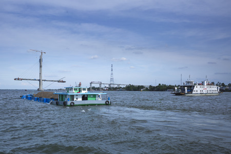 Tien Giang river,Tien Giang province, Vietnam - March 18, 2017: The bridge is still being built on, across Tien Giang river, Tien Giang Province, Viet Namのeditorial素材