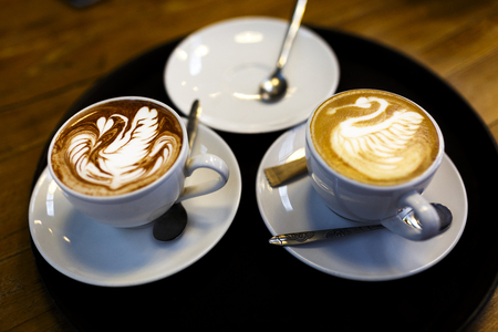 The cup hot capuchino on the wooden table background.の写真素材