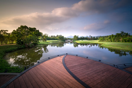Boat moored at a wooden pier in a beautiful morning on the lake at Flamingo Dai Lai resort of Vinh...