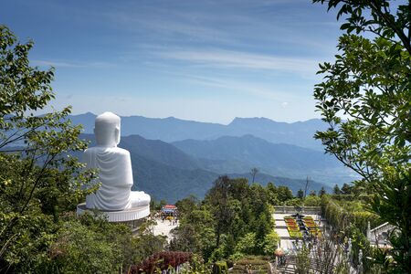 The giant Buddha statue on Ba Na Mountain looks down on Da Nang city, Vietnamのeditorial素材