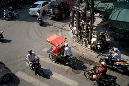 Hanoi capital, Vietnam - July 12, 2018: Cyclo or pedicab driver on Hanoi street. Cyclo is one of the most favorite vehicles for tourist when coming to Vietnam's cities.のeditorial素材