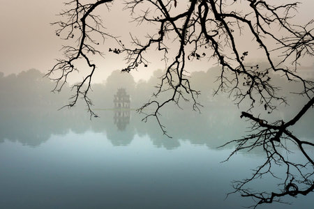 Hoan Kiem Lake ( Ho Guom) in the center of Hanoi in the fog in the morning. Hoan Kiem Lake is a famous tourist place in Hanoiの写真素材