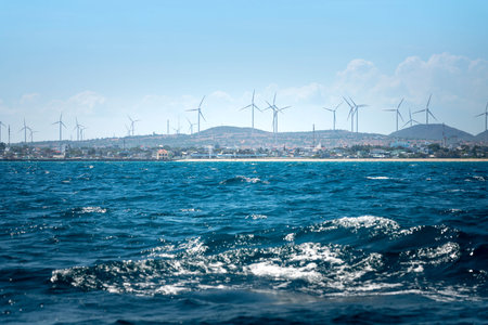 Windmill for electric power production, Wind turbines generating electricity on the sea at Binh...
