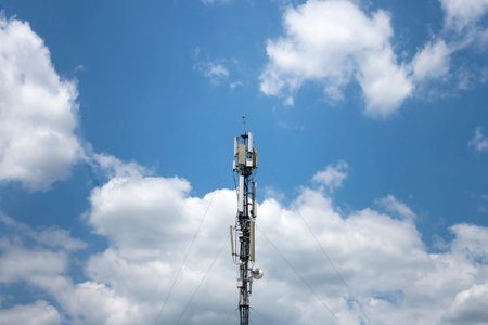 Telephone broadcast column against blue sky